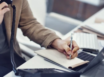 closeup-hand-writing-note-while-phone